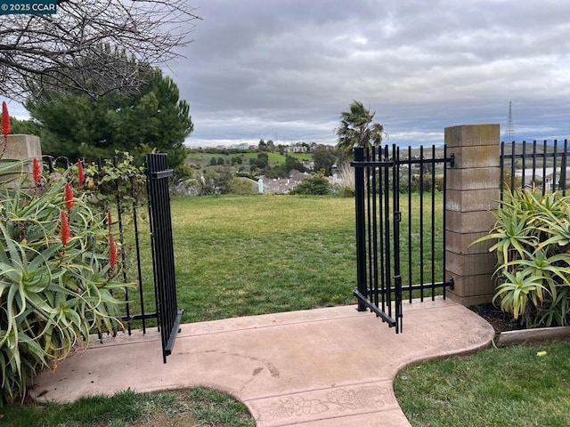 view of gate featuring a lawn