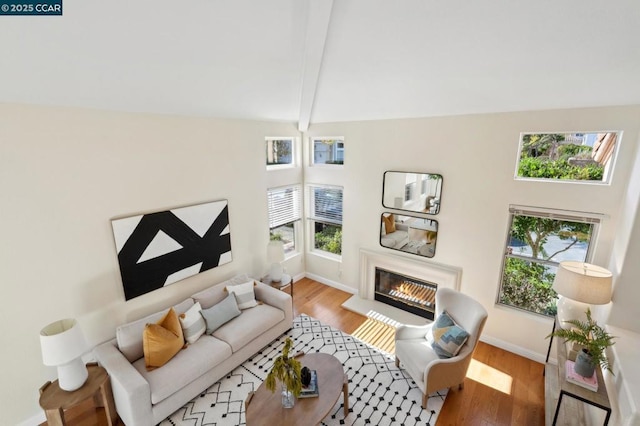 living room with lofted ceiling with beams and light wood-type flooring