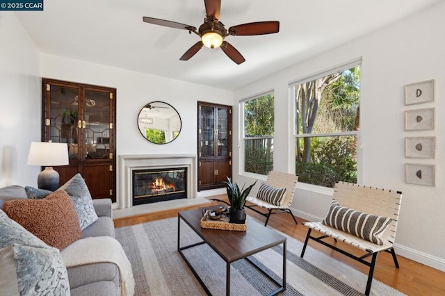 living room with ceiling fan and light hardwood / wood-style floors