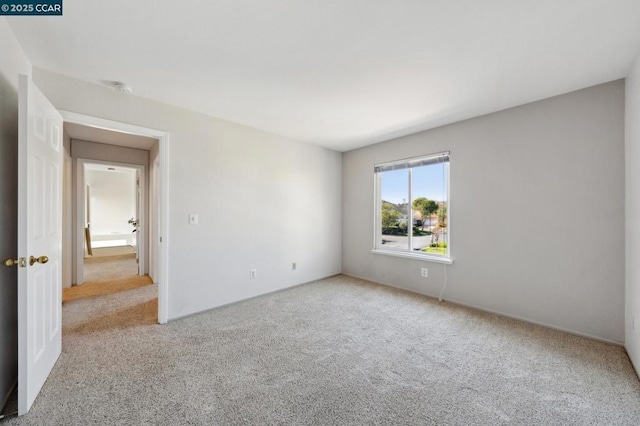 unfurnished room with light carpet