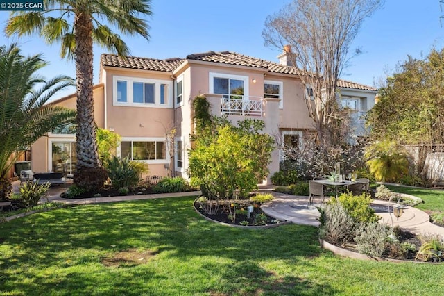 rear view of house with a patio and a yard