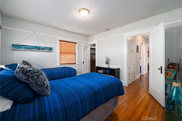 bedroom with dark wood-type flooring