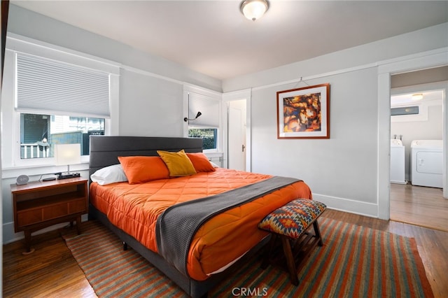 bedroom with washing machine and dryer and hardwood / wood-style floors