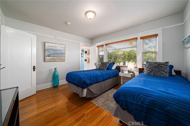 bedroom with dark wood-type flooring