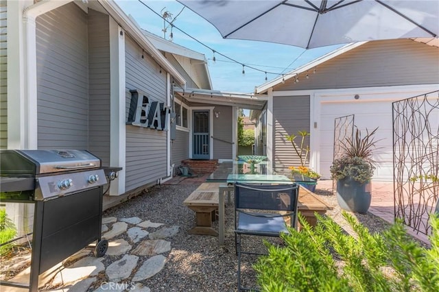 view of patio with a garage and grilling area