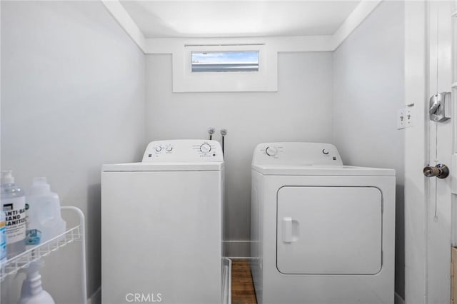 washroom featuring wood-type flooring and washer and dryer