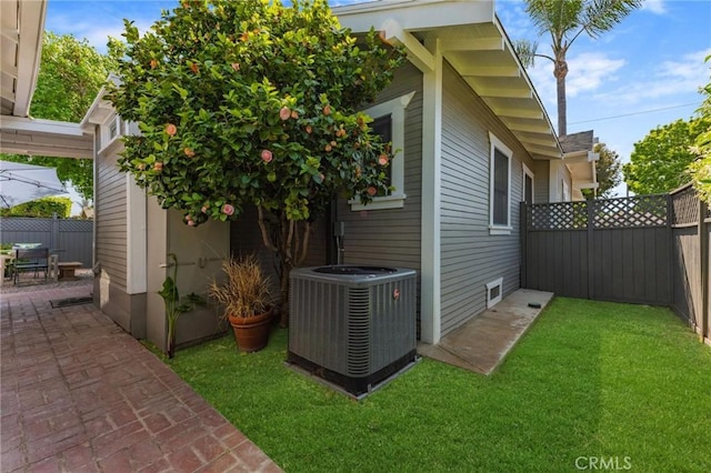 view of property exterior featuring cooling unit and a yard