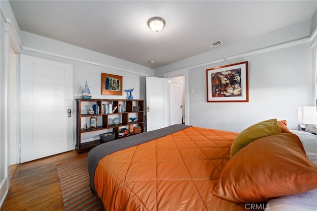 bedroom with dark wood-type flooring