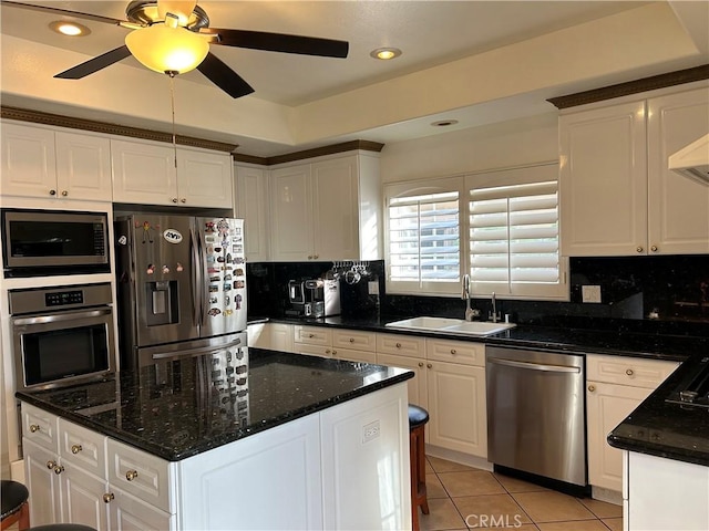 kitchen with sink, appliances with stainless steel finishes, white cabinets, and light tile patterned floors