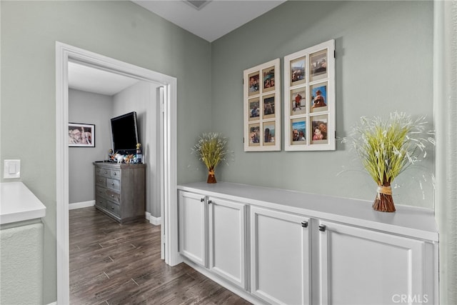 corridor with dark hardwood / wood-style floors