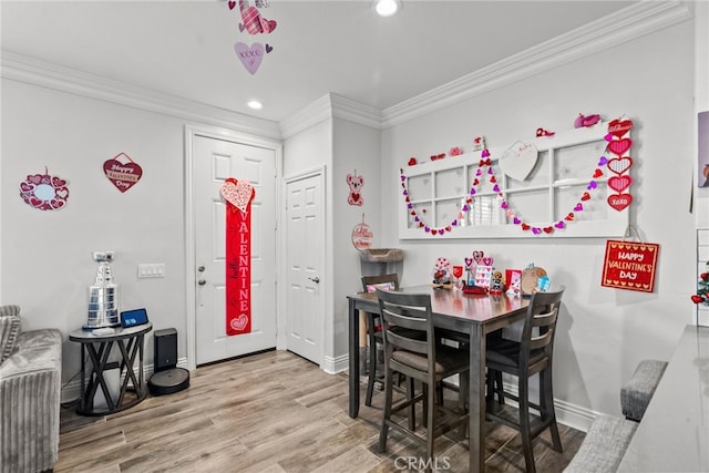 dining room with crown molding and wood-type flooring