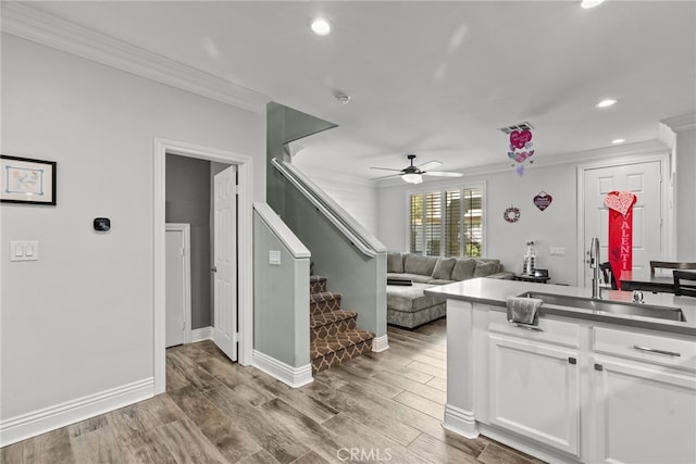 kitchen with sink, crown molding, and white cabinets