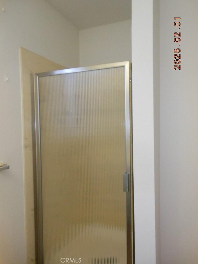 bathroom with a shower with shower door