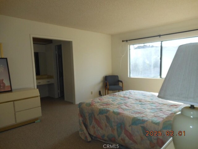 carpeted bedroom featuring a textured ceiling