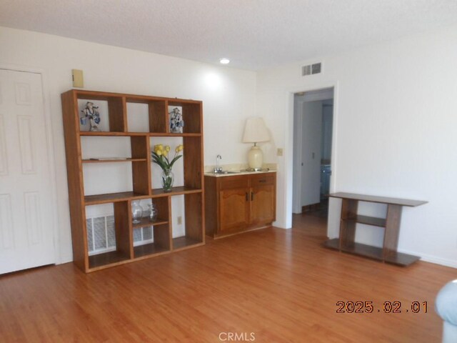 empty room with sink and hardwood / wood-style floors