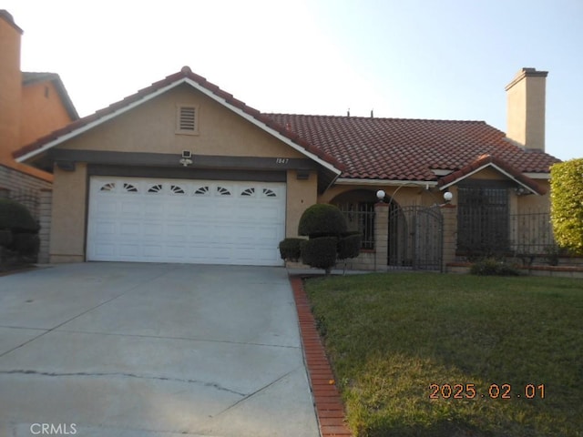 ranch-style house with a garage and a front lawn