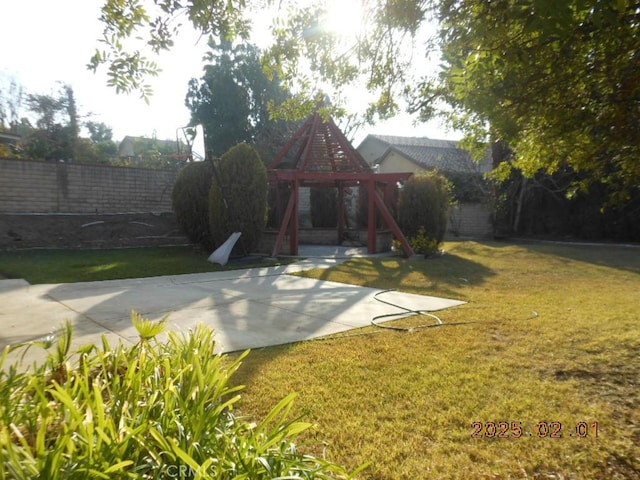 view of yard with a playground and basketball hoop