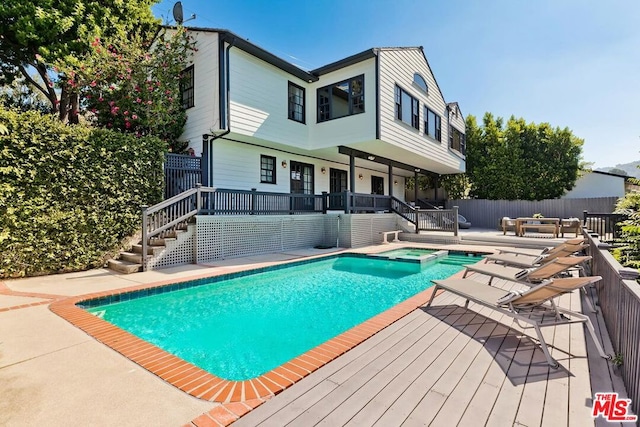 view of swimming pool with a patio area and an in ground hot tub