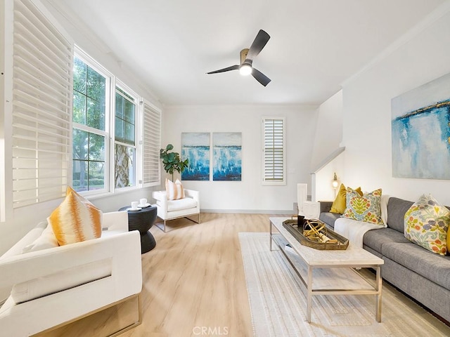 living area featuring a ceiling fan and wood finished floors