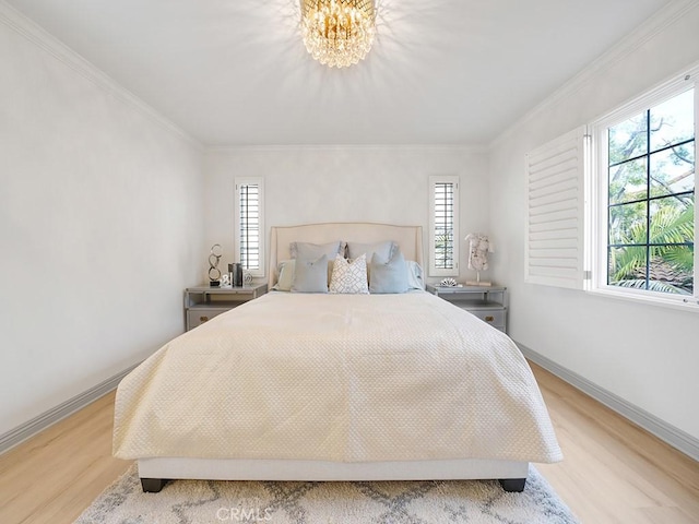 bedroom with crown molding, a notable chandelier, and light wood-type flooring