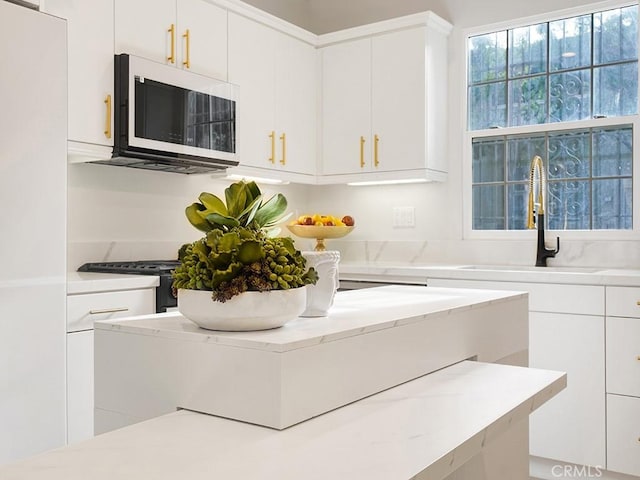 kitchen featuring sink and white cabinets