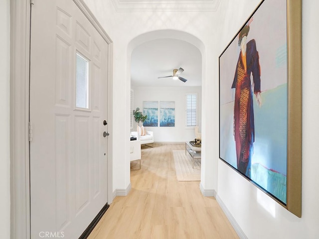 corridor with crown molding and light wood-type flooring