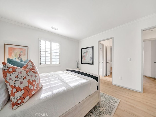 bedroom featuring hardwood / wood-style floors and crown molding