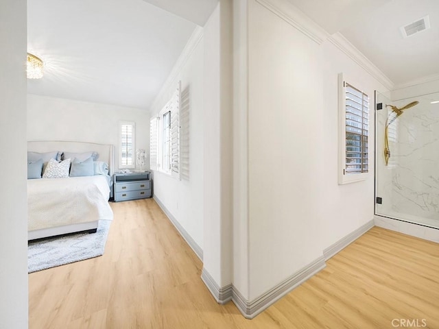 unfurnished bedroom with ornamental molding and light wood-type flooring