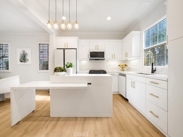 kitchen featuring stainless steel dishwasher, a center island, white cabinets, and white fridge