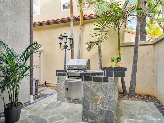 view of patio with area for grilling, a grill, and cooling unit