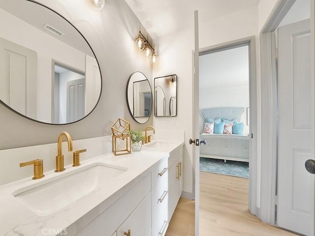 bathroom with vanity and hardwood / wood-style flooring