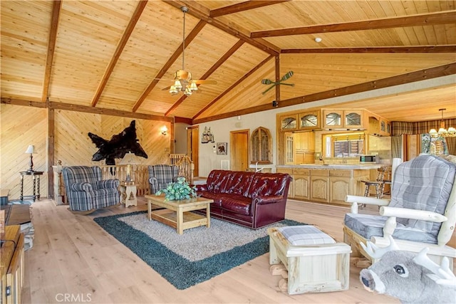 living room featuring beamed ceiling, light hardwood / wood-style floors, and wooden ceiling