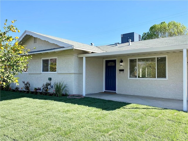 single story home featuring central AC, a front lawn, and stucco siding