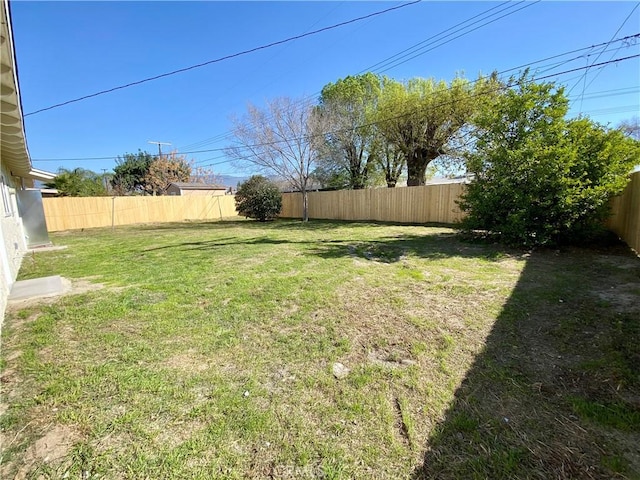 view of yard with a fenced backyard