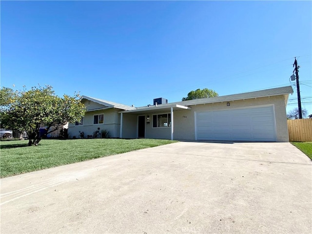 ranch-style house with an attached garage, driveway, a front lawn, and stucco siding