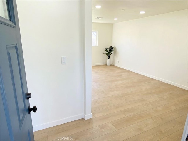 unfurnished room featuring recessed lighting, baseboards, and light wood finished floors