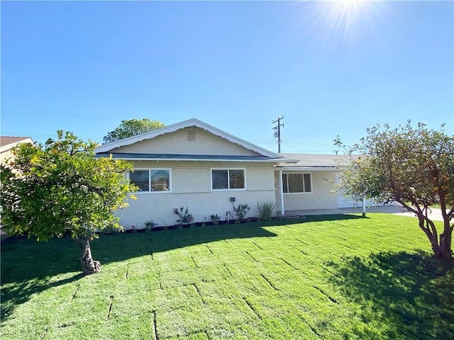 ranch-style house with a front lawn and stucco siding