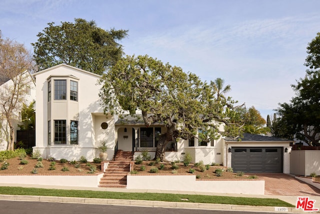 view of front facade featuring a porch and a garage