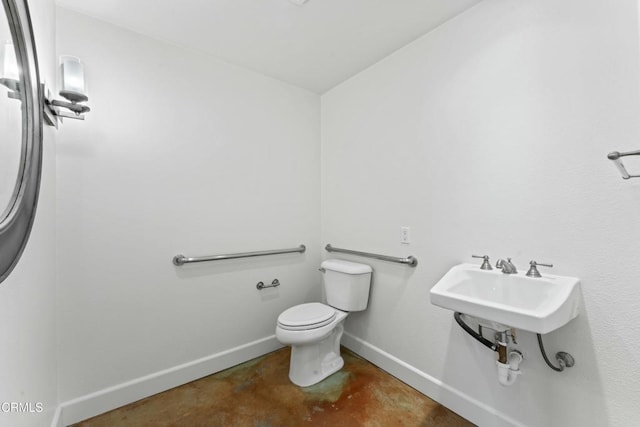 bathroom featuring concrete flooring and toilet