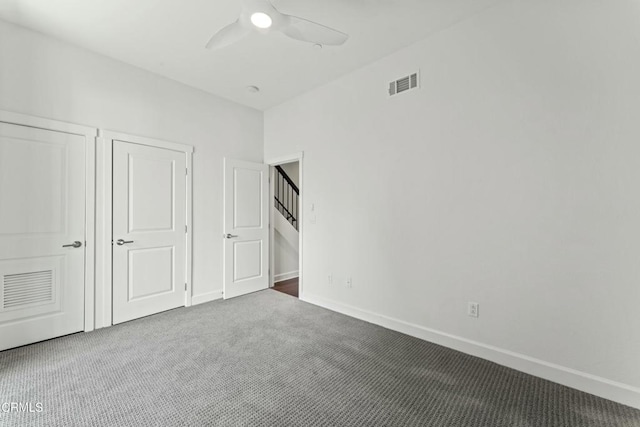 unfurnished bedroom with ceiling fan and carpet