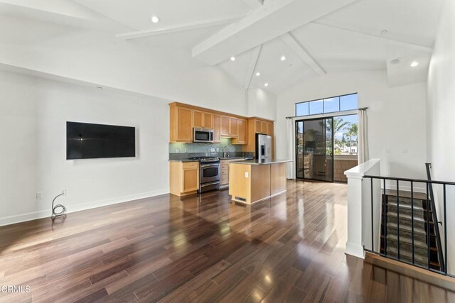 kitchen featuring appliances with stainless steel finishes, high vaulted ceiling, a kitchen island, dark hardwood / wood-style flooring, and beamed ceiling