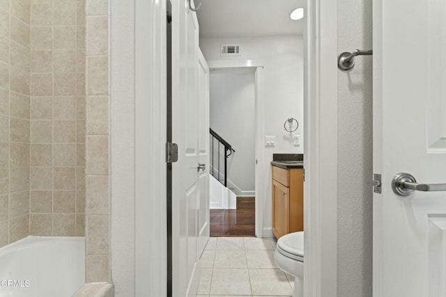 bathroom featuring vanity, toilet, and tile patterned flooring