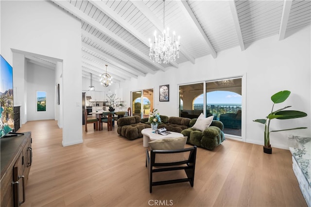 living room featuring beam ceiling, a chandelier, high vaulted ceiling, and light hardwood / wood-style flooring