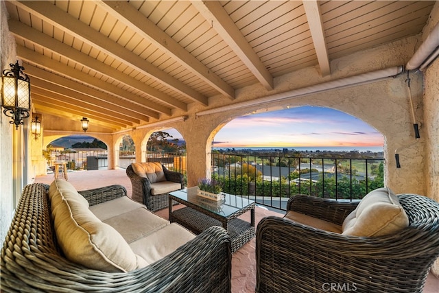 patio terrace at dusk featuring an outdoor living space