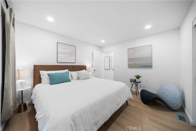 bedroom with hardwood / wood-style flooring