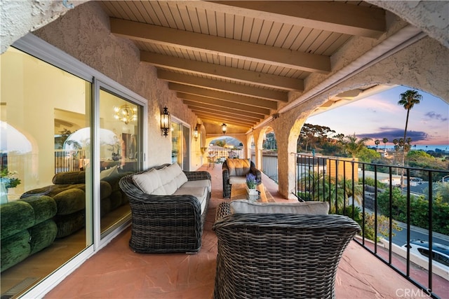 balcony at dusk featuring outdoor lounge area