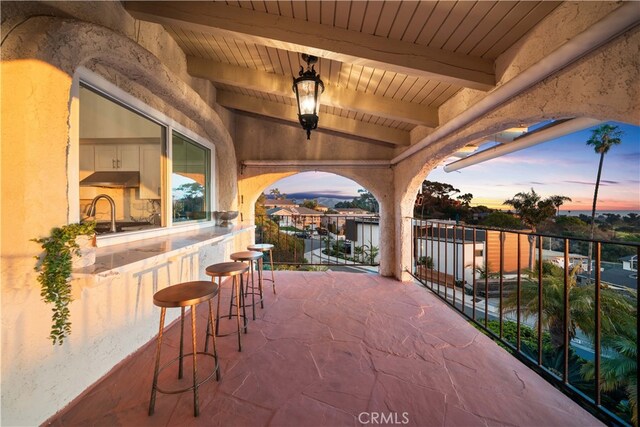 patio terrace at dusk with an outdoor wet bar