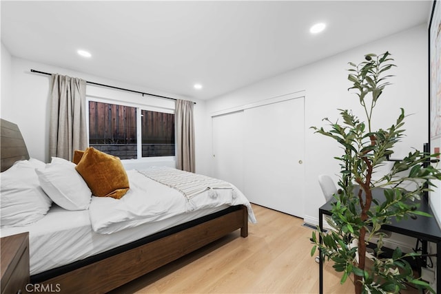 bedroom with a closet and light wood-type flooring