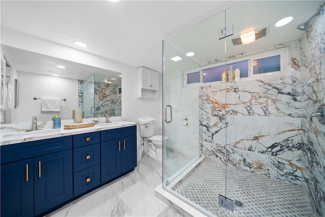 bathroom featuring vanity, toilet, and a shower with door