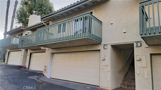 exterior space with a garage and a balcony